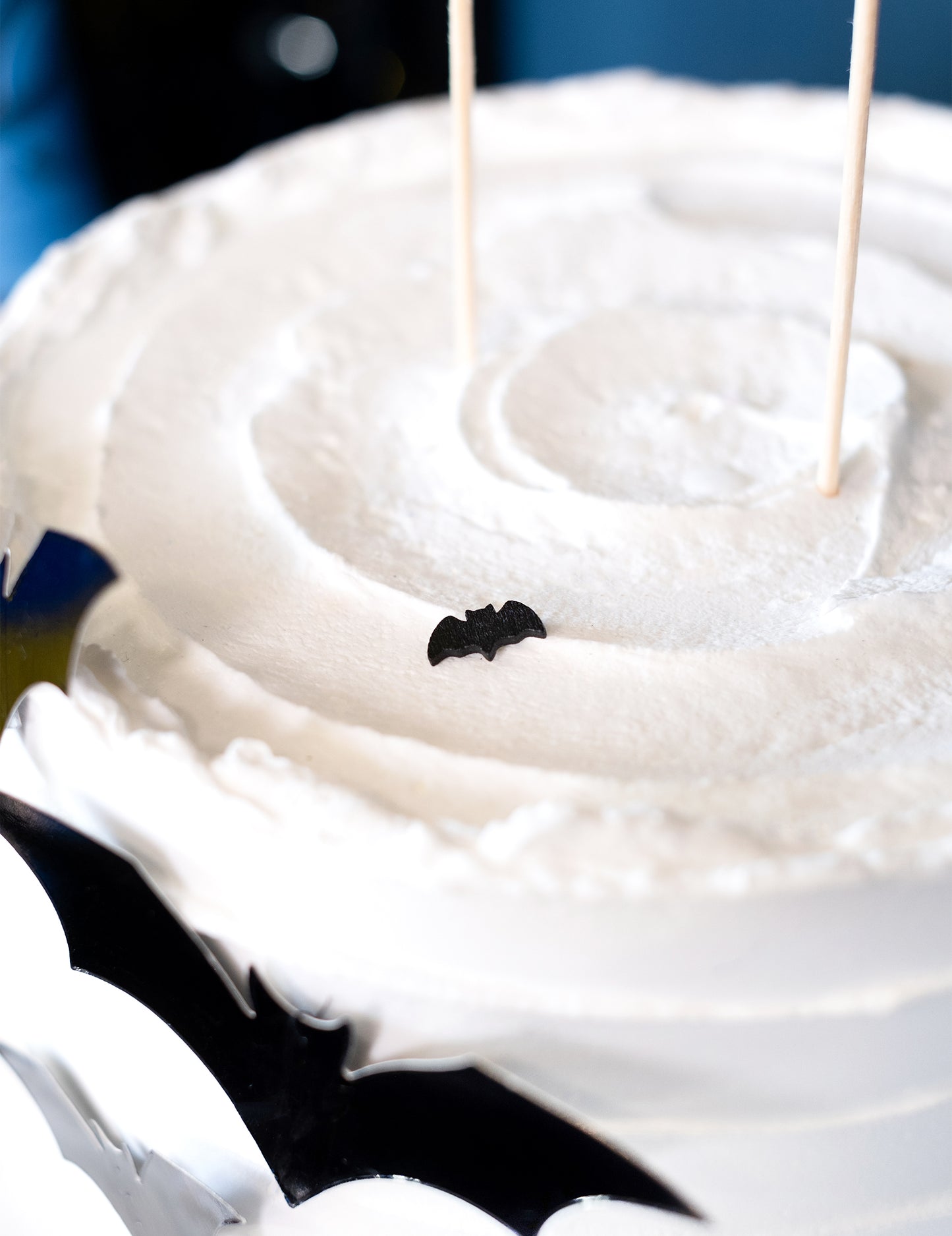 Détail d'un confetti posé sur un gâteau des 20 confettis de table chauve-souris Halloween noir
