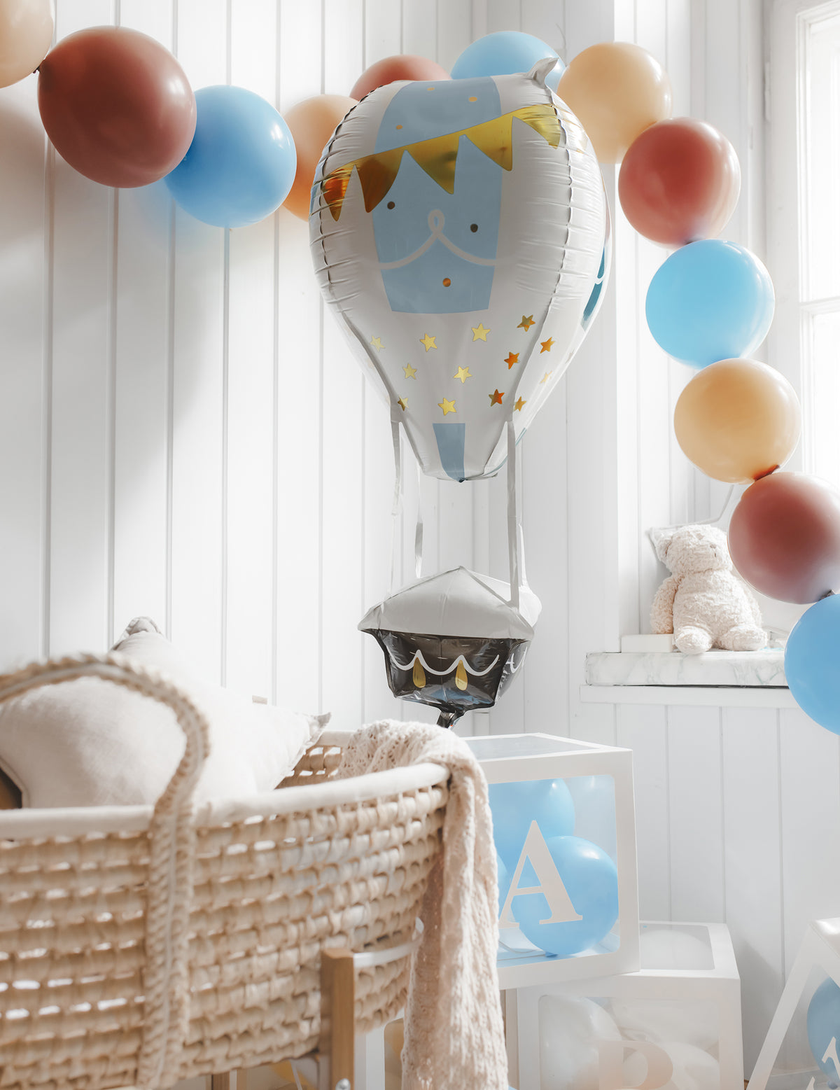 Mise en situation du ballon aluminium montgolfière dans une décoration de fête pour bébé