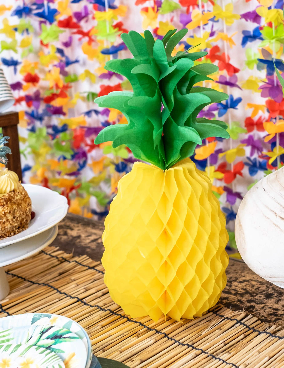 Decor de masă pe o masă de petrecere cu decorațiune din hârtie în formă de ananas