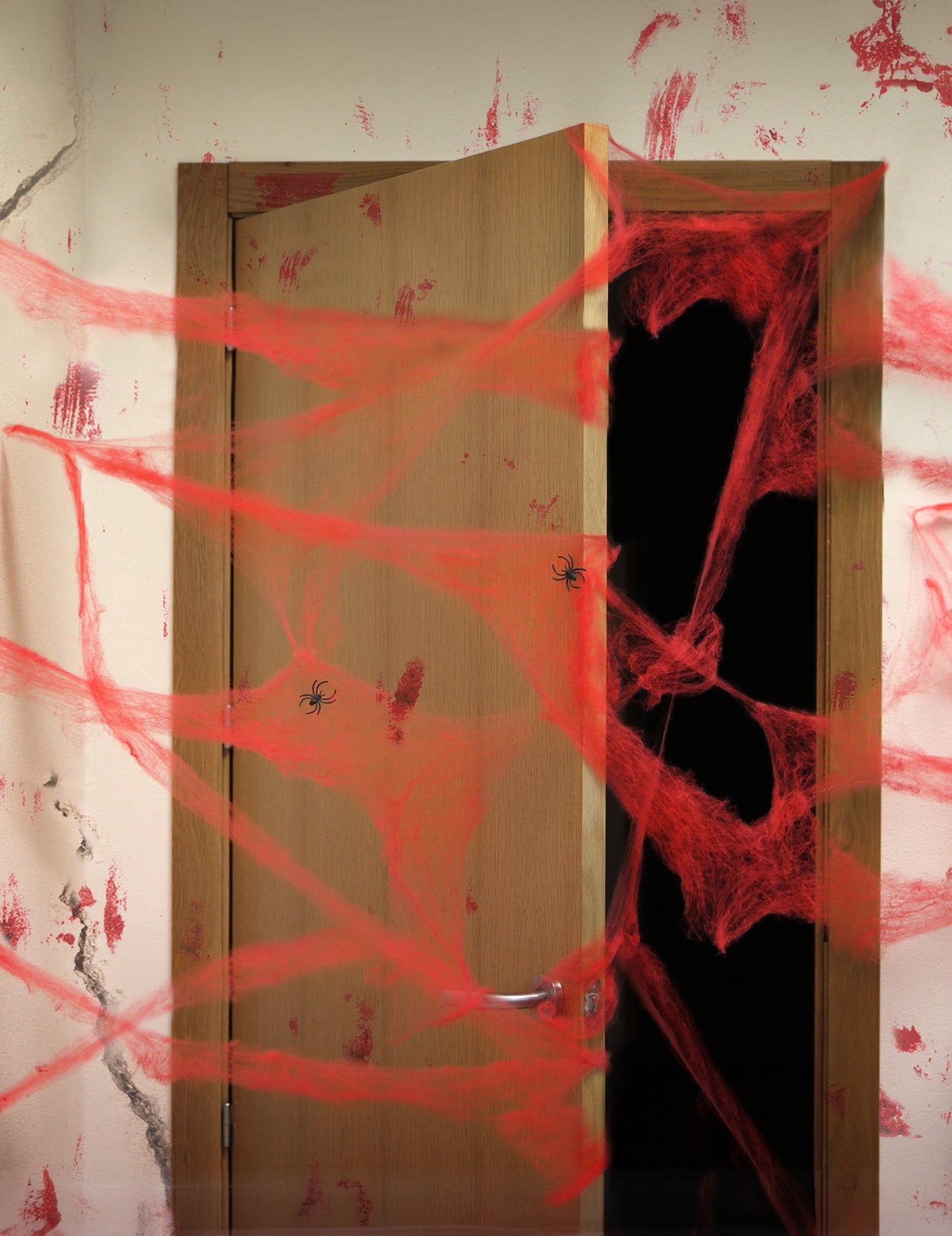Décoration toile d'araignée Halloween rouge avec araignées noires