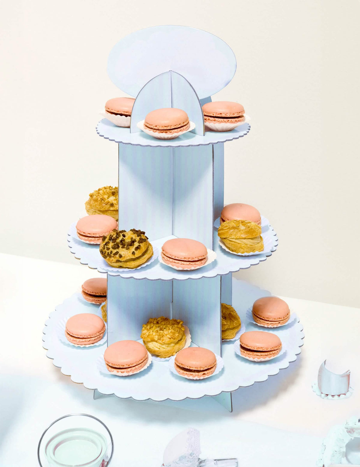 Plasare cu macarons pe suportul de brioșă din carton pentru baby shower