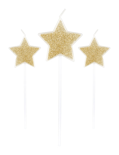 3 bougies sur pic étoiles pour fête paillettes champagne