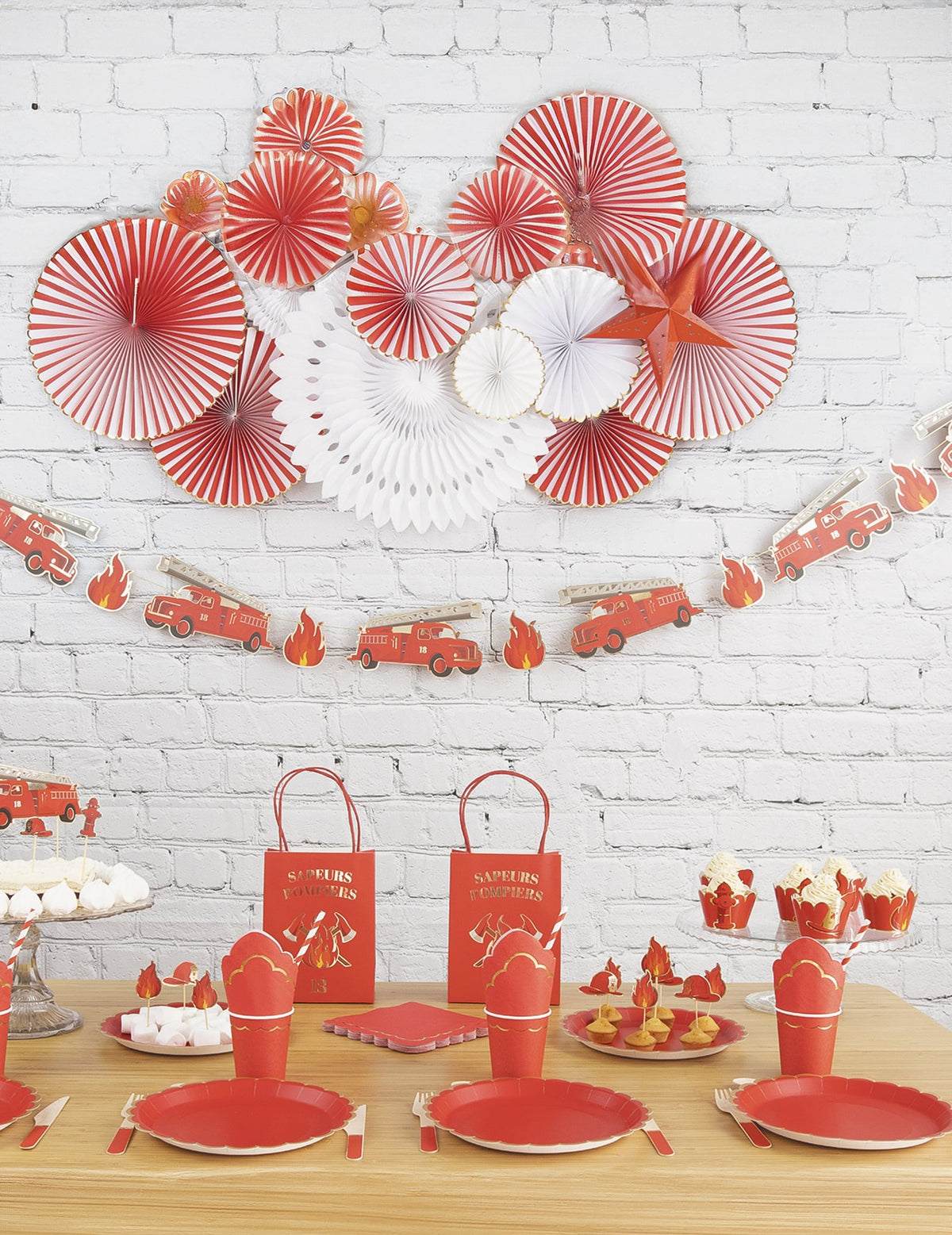 Vue du buffet de fête décoré avec la guirlande en carton Pompier
