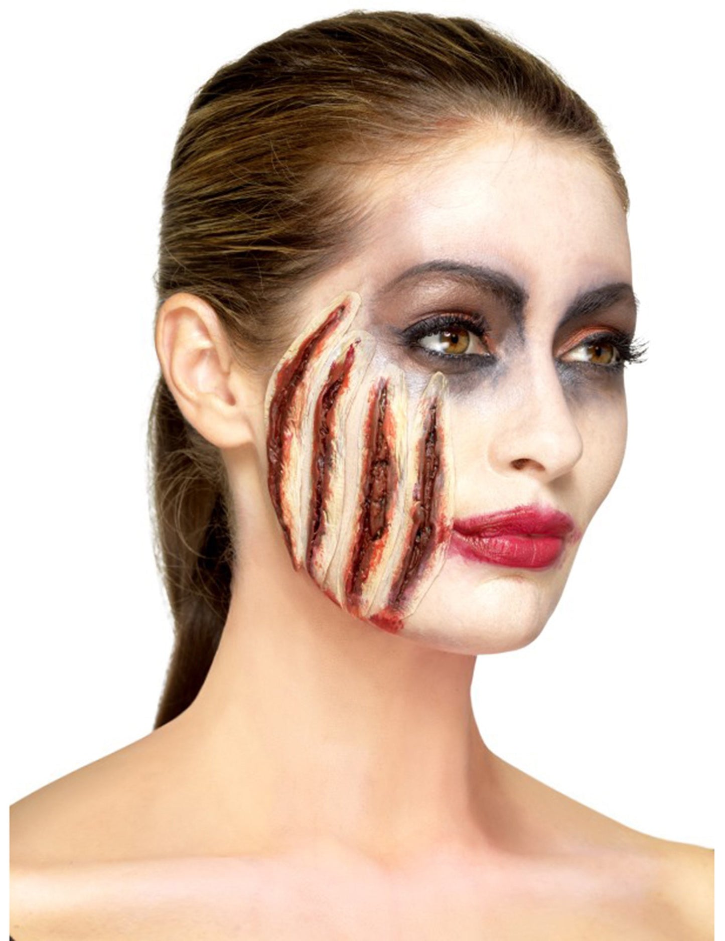 Vedere din profil a protezei din latex cu tăieturi de Halloween