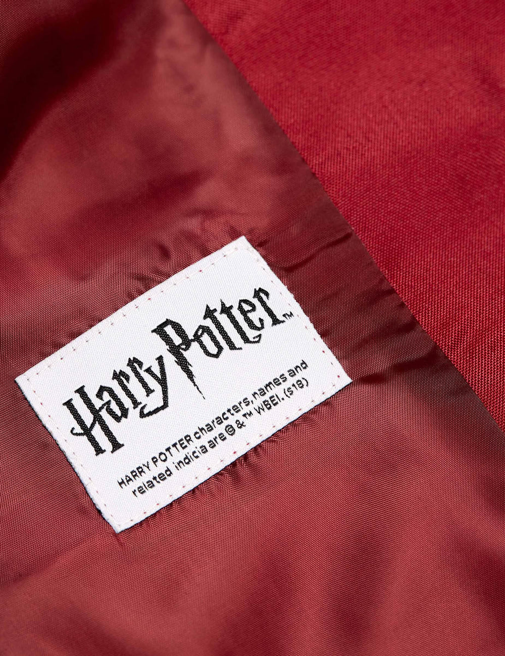 Detaliu al etichetei Harry Potter a jachetei doamnei Gryffondor pentru femeie Suitmeister